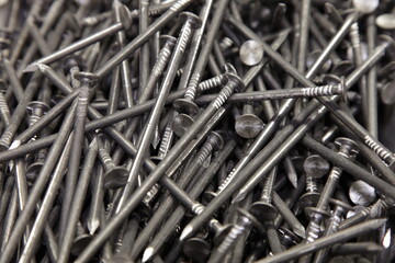 A lot of new common nails. Carpentry construction fasteners. Technical texture for the background.