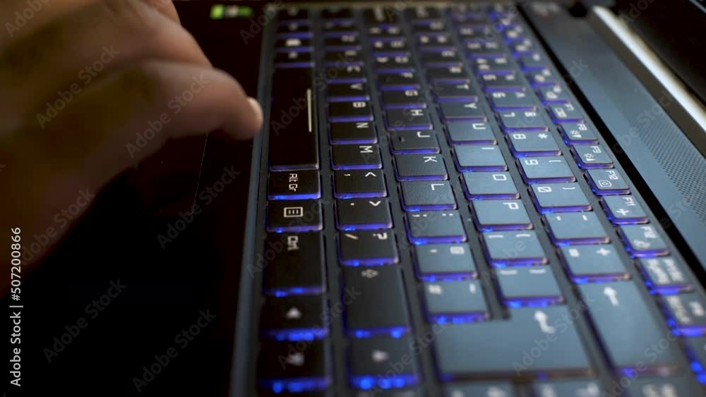 Poster hacker typing on laptop keyboard, close up view on hands