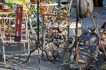 pieces of vintage furniture in the antiques stall in the outdoor flea market where rare bargains...