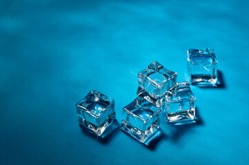 Clear ice cubes for cooling drinks on a blue background.