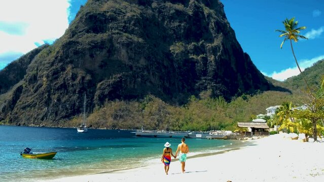 St Lucia Caribbean, couple men and women on vacation,Huge pitons drone view at Saint Lucia sugar beach St Lucia mountains at the beach with clear ocean
