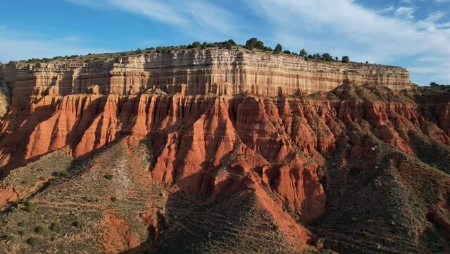 Forward drone flight in a red desset cayon in Teruel, Spain, at dawn. Beautiful colors
