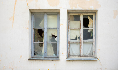 Fototapeta na wymiar Broken windows in an old house.