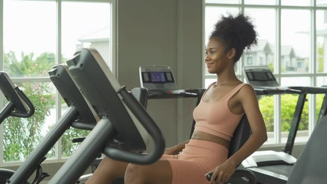 Portrait of Black African American woman at gym fitness center club. Muscle strength training workout. Exercise indoor with sport equipment. Athletic. People lifestyle. Recreation.