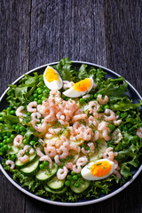 pink cocktail shrimps salad with veggies on plate