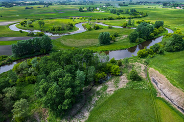 Fototapeta na wymiar Nida River Bends in Poland. Drone View at Sunny Spring Day