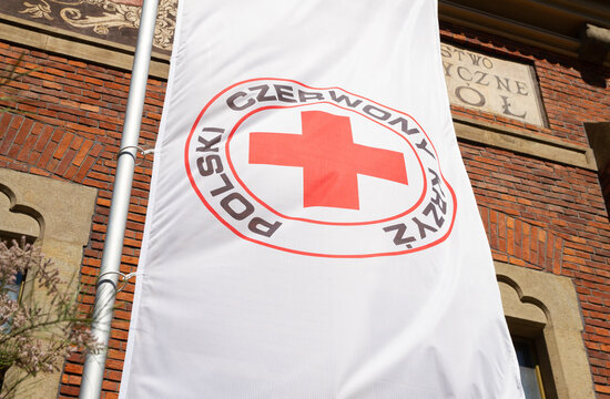Polish Red Cross (Polski Czerwony Krzyż, PCK), part of International Red Cross and Red Crescent humanitarian movement. Flag with logo in front of Kraków branch on May 19, 2022 in Krakow, Poland.