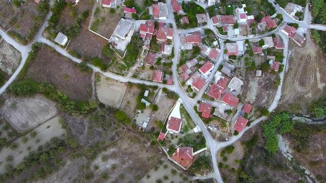 Aerial view of small village and crop fields at Autumn