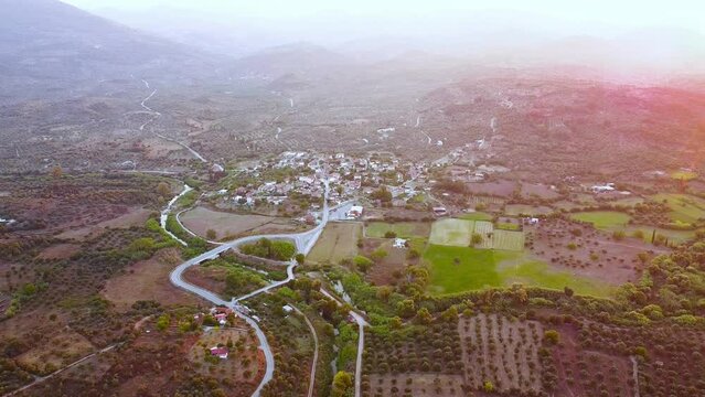 Aerial view of small village and crop fields at Autumn