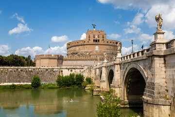 Obraz premium Cityscape of Rome with Castel Sant'Angelo and Ponte Sant'Angelo across the Tiber river on a sunny summer day. Rome, Italy