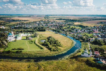 Fototapeta premium Aerial view panorama of cityscape of the Suzdal Kremlin on a bend of the Kamenka river. Russia, Vladimir region, Golden Ring of Russia