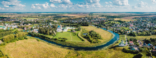 Aerial view panorama of cityscape of the Suzdal Kremlin on a bend of the Kamenka river. Russia,...