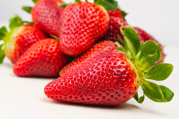 group of strawberry on white background with one strawberry in the foreground