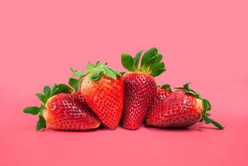 group of strawberries on pink background