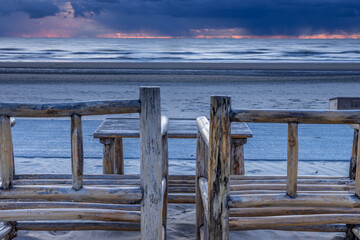 Two chairs on Zandvoort beach at sunset on the North Sea - obrazy, fototapety, plakaty