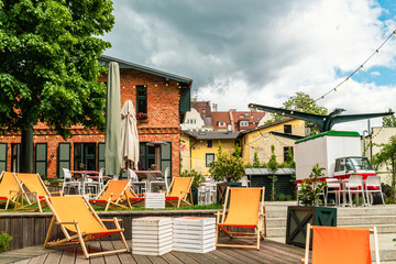 Orange lounge chairs in a green summer garden	