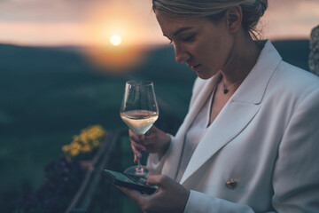 Business woman drinking white wine 