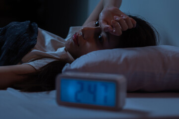 Young Asian woman suffer from insomnia can't sleep at night awaken from stress mental health problem or migraine. Young people health care psychiatry concept. - obrazy, fototapety, plakaty