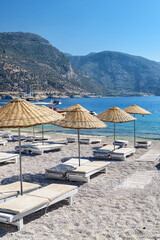 Beach umbrellas and sun loungers on Oludeniz Beach in Turkey