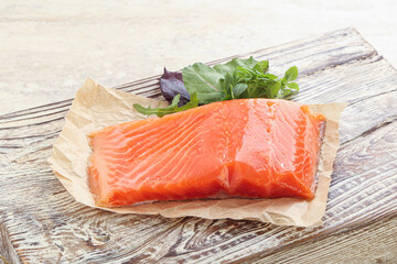 Raw salmon fillet over board