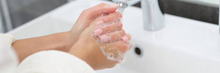 Woman washing her hands with soap, close-up