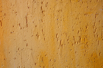 Old texture yellow acrylic plaster. Wall surface decoration materials