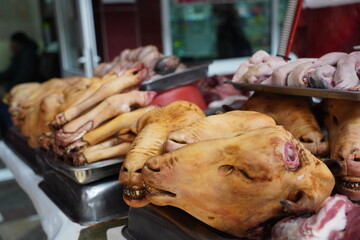 Almaty, Kazakhstan - 03.25.2022 : Lamb heads and various parts of meat are put up for sale in the market.