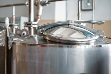 Metal lid with handle on reservoir top at production plant