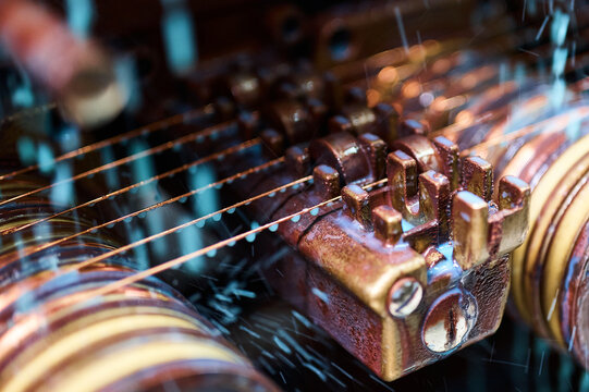 Cooling oil poured down on vintage coil winder machine tool