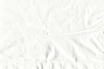 Texture of white cotton crumpled fabric. Clean cloth. Background of coarse natural fabric. Abstract fabric background