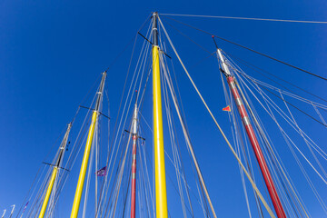 Colorful masts of sailing ships in the harbor of Harlingen, Netherlands