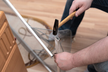 Man repairing mosquito net at home. Home improvement concept