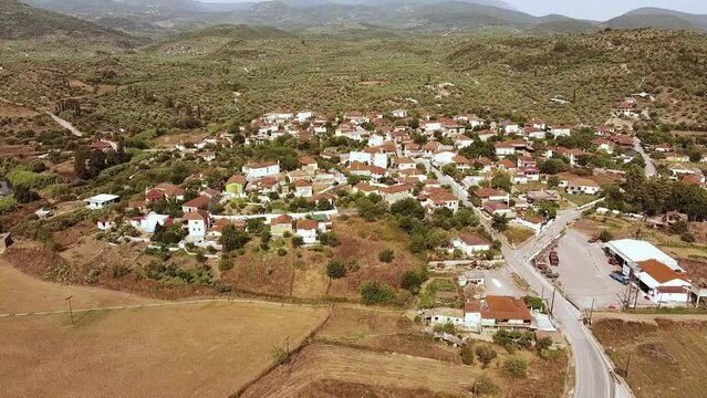 Aerial view of small village and crop fields at Autumn