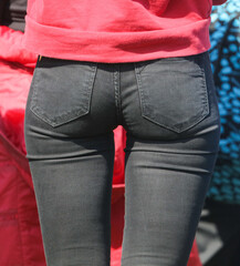Legs of a girl in black jeans.