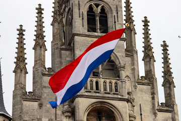 Fototapeta premium Flags on the ancient town hall at the Markt of Gouda during celebration of 750 years Gouda