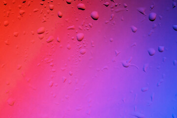 Colored background with rain effect on the window