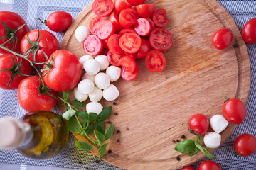 Ingredients for Caprese salad - Mini mozzarella cheese in glass bowl, tomato and basil
