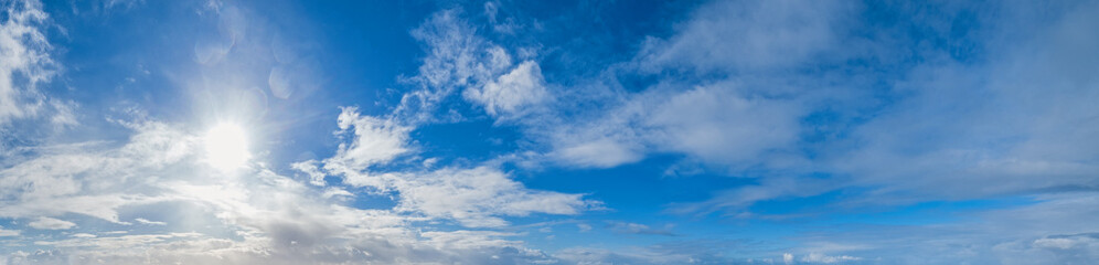 Naklejka na ściany i meble Blue sky with clouds in sunshine (wide natural cloudscape background panorama)