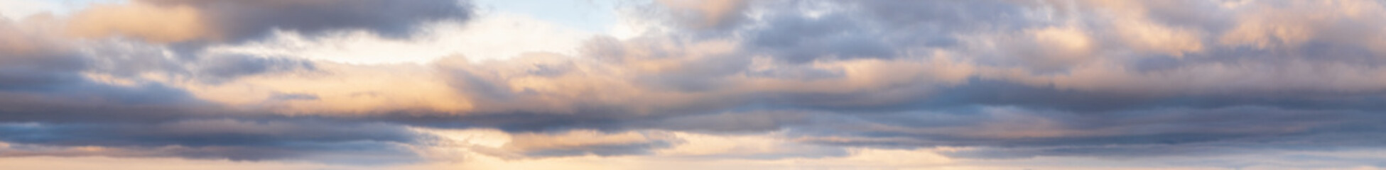 Clouds in evening dusk sky panoramic view. Climate, environment and weather concept sky background.