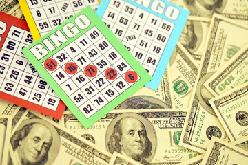 Many bingo boards or playing cards for winning chips and big amount of dollar bills. Classic...