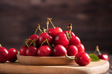 Ripe sweet cherries on wooden background