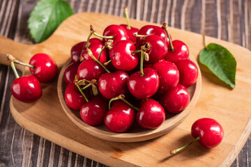 Ripe sweet cherries on wooden background