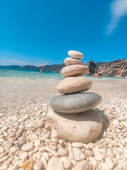 woman in blue swimsuit at the rock sunbathing
