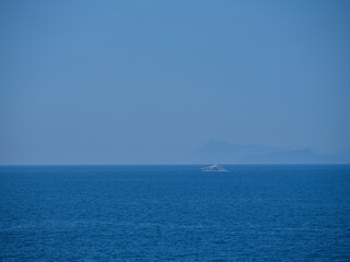 tourist boat traveling in the blue sea