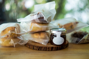 Delicious scone in plastic bag with jam in a bottle - obrazy, fototapety, plakaty