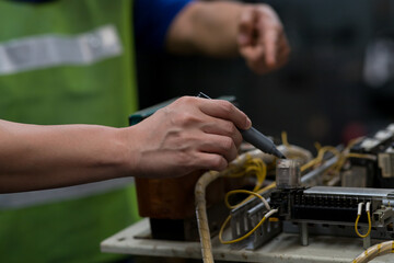 Hands of engineer male worker maintenance electronics of machine at the industry factory. Factory worker manufacturing industry concept.