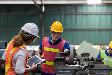 Group of male and female worker maintenance machine in industry factory. Technician worker working, repair machine lathe metal in the industry factory