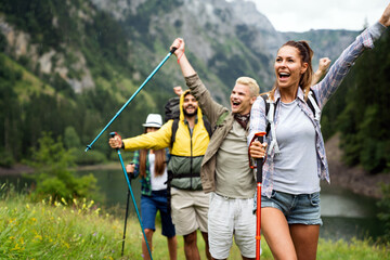 Adventure, travel, tourism, hike and people concept. Group of happy friends with backpack outdoors - obrazy, fototapety, plakaty