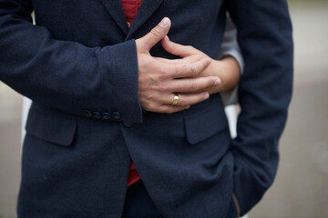 the bride hugs the groom at the wedding, close-up of the hands of the newlyweds.