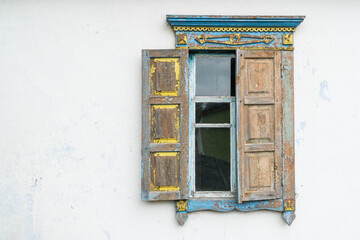 Carved wooden windows in old wooden houses in Oleshnia village, Chernihiv region, Ukraine.